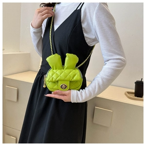 Detailed close-up of a neon green bunny-shaped crossbody bag with quilted PU leather texture