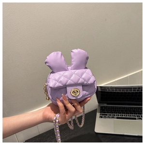 Close-up of purple quilted crossbody bag featuring cute rabbit ears and gold chain strap
