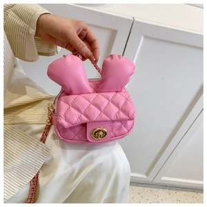 Detail of pink quilted mini crossbody bag with cute rabbit ears and gold twist lock
