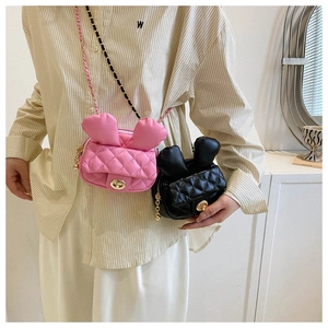 Detail view of mini quilted crossbody bags with cute rabbit ears and gold metal chain strap