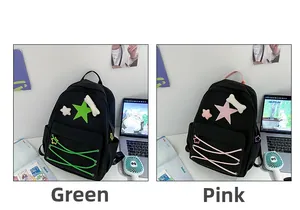 Detail view of pink and green canvas star backpacks with decorative plush charms
