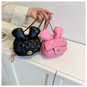 Detail of cute rabbit crossbody bags with quilted leather and gold chain straps