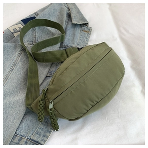 Detailed view of army green nylon chest bag with woven rope zipper and adjustable strap