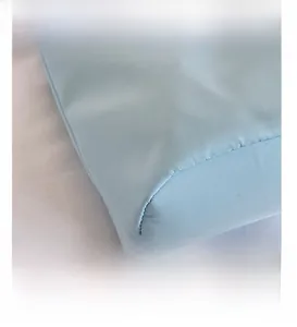Close-up detail of light blue nylon fabric showing precise stitching and matte texture