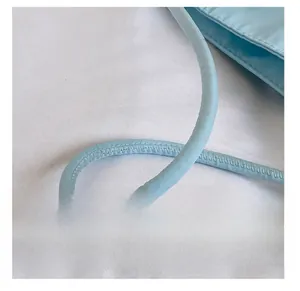 Detail view of reinforced stitching on the baby blue nylon tote bag handle straps
