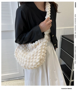 Detailed view of the three-dimensional bubble texture on this off-white quilted shoulder bag