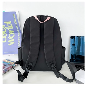 Rear view of black nylon backpack with pink top handle showing straps and adjustable buckles