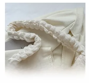 Close-up of comfortable ruched handle on white puff cloud textured shoulder bag