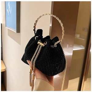 Detailed view of the sparkling rhinestone bucket bag with golden metal handle and chain