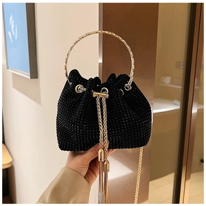 Detail of black drawstring bucket bag with sparkling rhinestones and gold chain tassels