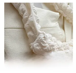 Close-up of the bubble texture and quilted detail on this cream crossbody bag