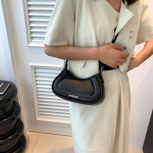 Minimalist black crescent shoulder bag with leather finish and adjustable strap