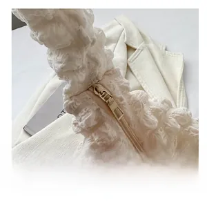 Macro detail of high-quality light gold metal zipper on white popcorn texture cloud bag