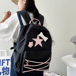 Japanese style black star backpack for school with cute charms and pink ribbon details