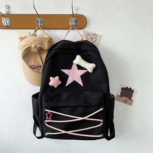 Cute school backpack with pink stars, bone pendants and cross-tie design for girls