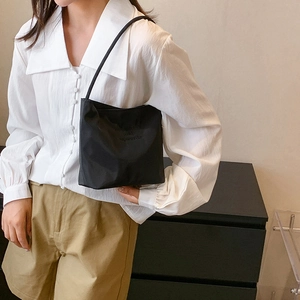 Minimalist black nylon shoulder tote bag for women featuring lightweight design and sleek straps