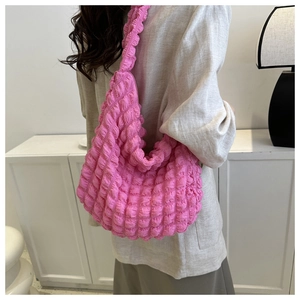 Detailed view of the bright pink bubble textured fabric on this cloud crossbody bag