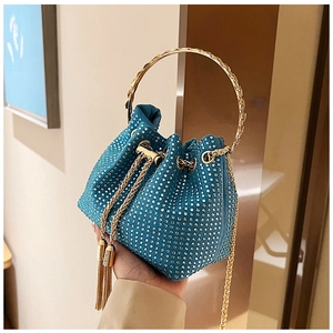 Detailed view of blue rhinestone bucket bag with gold ring handle and tassel drawstring