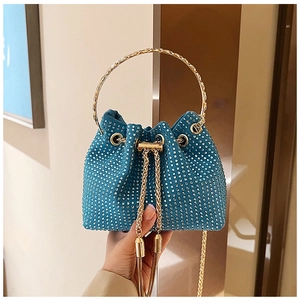 Detail of blue rhinestone bucket bag showing metal circular handle and drawstring