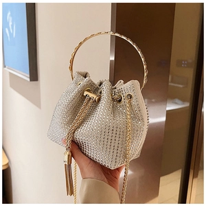 Detailed close-up of a sparkling rhinestone bucket bag with golden handle and silk drawstring