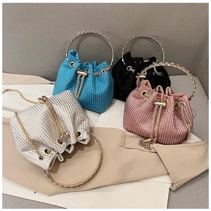 Sparkly rhinestone bucket bags in blue, black, silver, and pink with metal ring handles