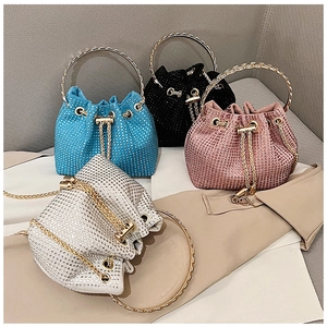 Detail view of bucket bags with rhinestones in blue, black, pink and silver finishes