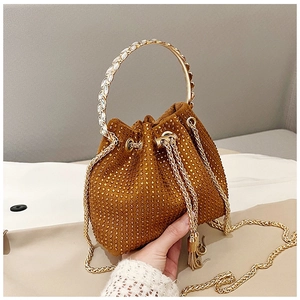 Detail of brown rhinestone bucket bag with drawstring, tassel, and metallic ring handle