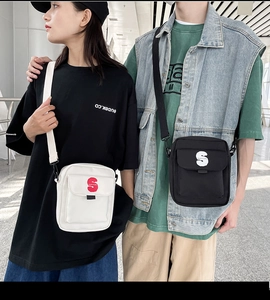 Bolsos bandolera de nailon en blanco y negro con un detalle distintivo del logotipo S