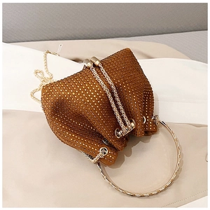 Close-up of brown rhinestone bucket bag featuring golden ring handle and chain strap