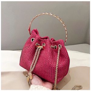 Detailed close-up of pink rhinestone bucket bag with gold circular metal handle