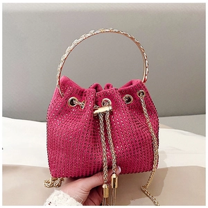 Macro detail of the shimmering rose red rhinestone bucket bag with golden chain handle