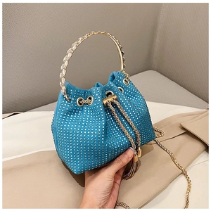 Detail of blue rhinestone bucket bag with gold ring handle and drawstring tassels