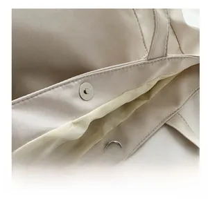 Close-up of secure metal magnetic buckle closure and durable beige nylon fabric lining