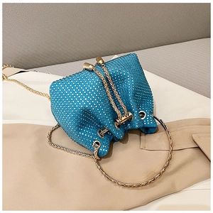 Detail of lake blue rhinestone bucket bag with gold ring handle and drawstring closure