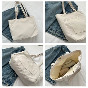 Detail view of large nylon tote bag showing magnetic closure and interior storage