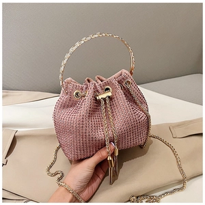 Close-up of pink rhinestone bucket bag with metal ring handle and sparkling crystals