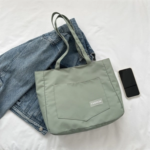 Simple light green nylon tote bag with fashion label and large front pocket for daily commute