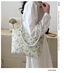 Detailed close-up of light green floral lace tote bag with woven hemp rope straps