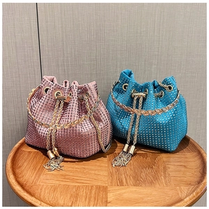 Close-up of pink and blue rhinestone bucket bags with gold chains and tassels