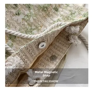 Detail showing the magnetic closure and floral lace fabric on a straw tote bag