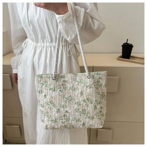 Detail of floral lace tote bag with white braided rope handles and metal eyelets