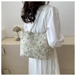 Detailed back view of a lace embroidery tote bag with floral patterns and woven straps