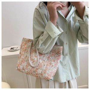 Detail of floral lace texture and cotton rope handles on the elegant tote bag