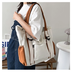 Detail of the large canvas tote bag showing the contrast stitching and adjustable strap