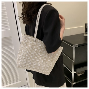 Lace embroidery tote bag with cotton rope handle shown on a stylish woman's shoulder