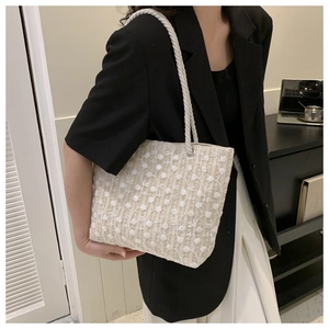 Close-up of elegant white lace embroidery texture on a large capacity canvas tote bag