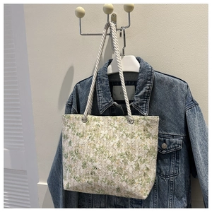 Detail view of floral lace pattern and sturdy white rope handle on the summer tote bag