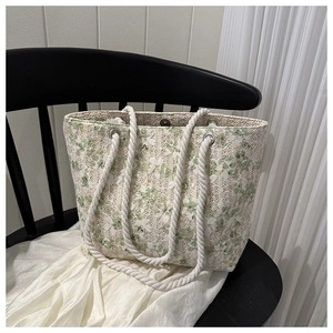 Detailed view of lace floral tote bag with cotton rope handles on a black wooden chair