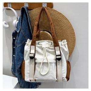 Detail of high-capacity contrast tote bag with drawstring closure and buckle for daily use