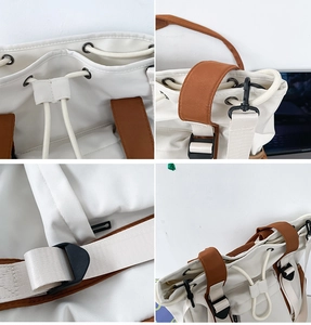 Detail view of contrast color bucket bag showing drawstring closure and metal hardware
